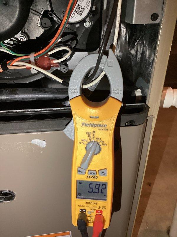 Completed comprehensive maintenance inspection on 3-year-old heat pump system. Performed electrical diagnostics using clamp meter on indoor air handler unit, measuring blower motor amperage at 5.92 amps, confirming proper operation within manufacturer specifications. Proceeded to outdoor condensing unit where capacitor testing was conducted, measuring 3299 microfarads to verify component integrity and starting capabilities. All electrical connections inspected and found secure, system operating efficiently with no issues identified.