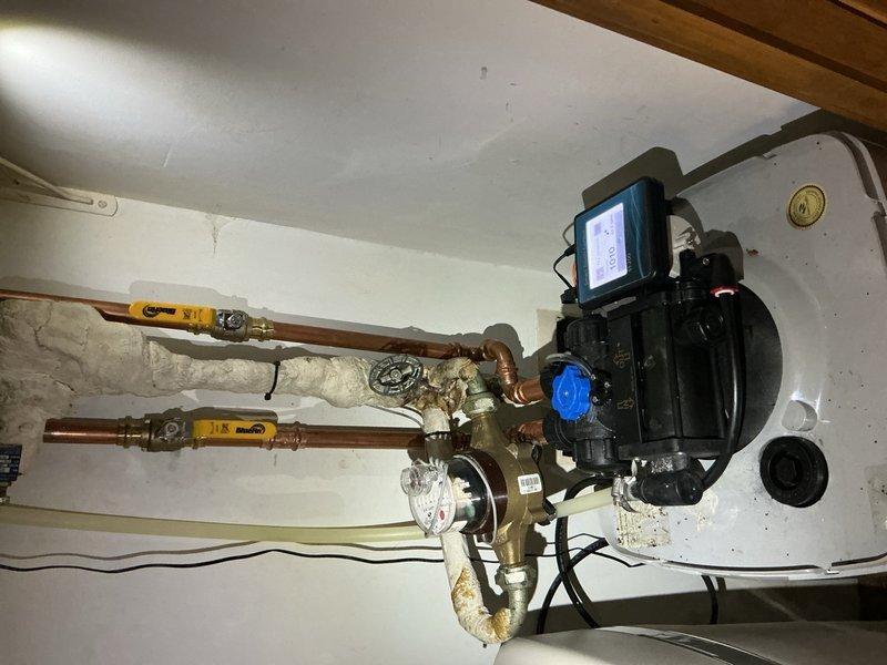 Replaced failed internal tank assembly on Hague water softener system and installed surge protector to protect equipment from electrical damage. Utilized existing copper piping connections with brass fittings and verified proper operation of digital control unit and valve system upon completion.