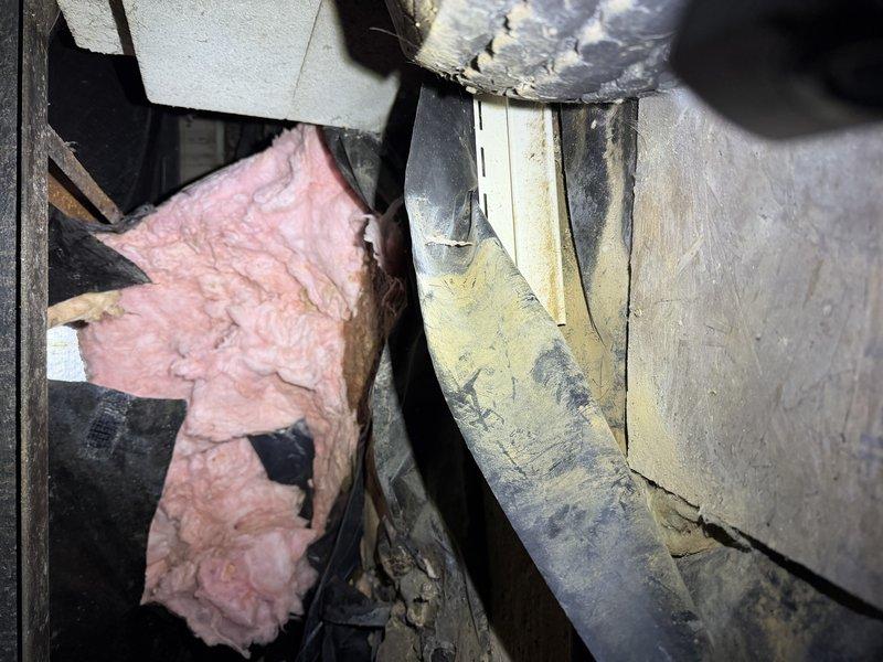 Responded to master bathroom with strong sewer smell emanating from toilet area. Inspected toilet and surrounding plumbing connections, documented conditions with photos showing bathroom layout and accessible plumbing infrastructure. Coordinated with insulation contractor who discovered and removed deceased animal from crawlspace/attic area near bathroom plumbing, which was identified as source of odor. Additional concerns noted include inadequate toilet flushing performance requiring multiple flushes and separate issue in guest bathroom where showerhead leak is causing water damage to adjacent bedroom carpet through wall penetration.