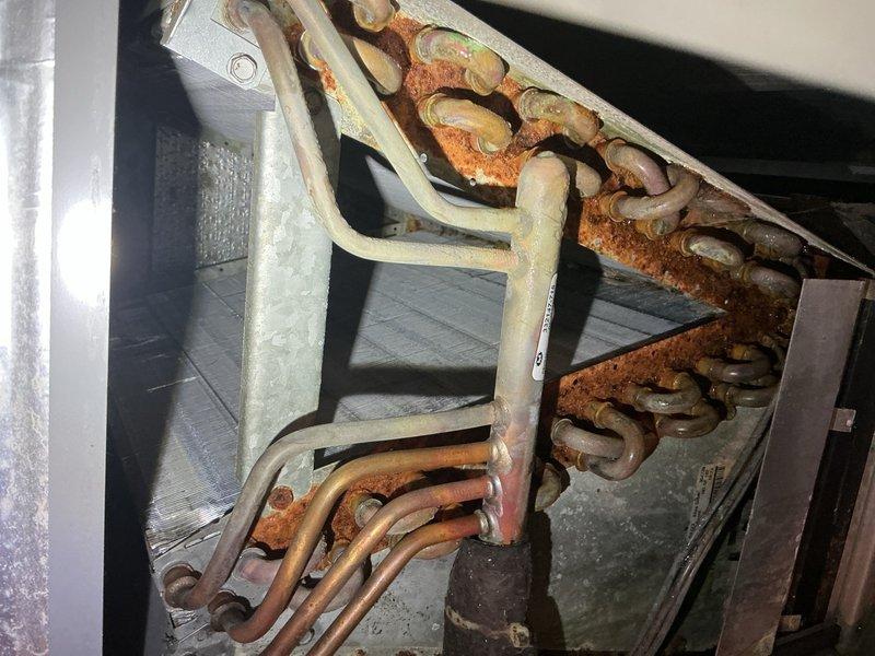 Completed comprehensive CPM A/C inspection and tune-up on property with both central air conditioning system and mini-split unit as first-time service visit. Performed blower wheel cleaning as previously estimated, addressing accumulated debris and ensuring optimal airflow through the system. Inspection revealed significant rust and corrosion on evaporator coil copper tubing and internal components, indicating prolonged moisture exposure that will require monitoring for potential future service needs.