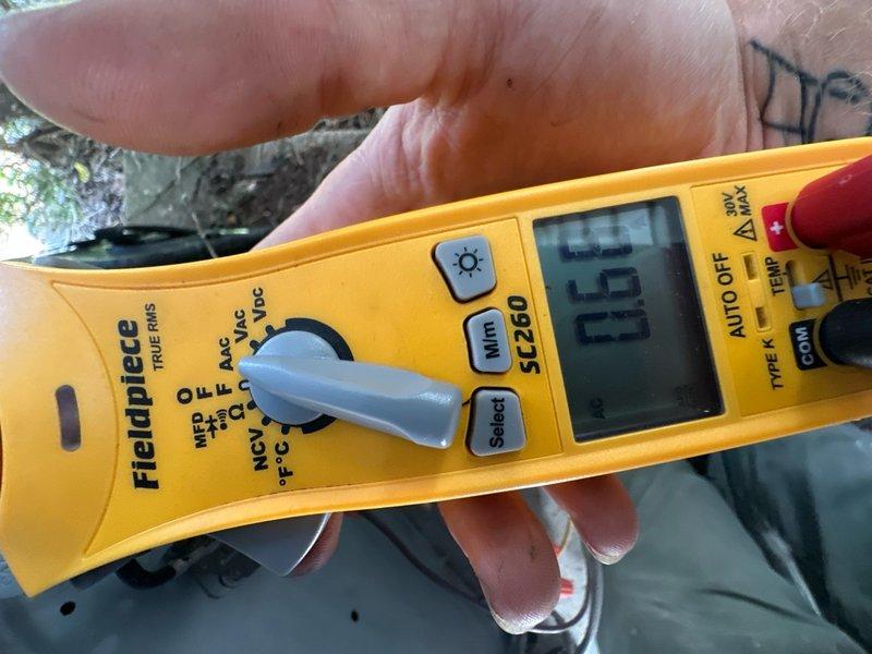 Completed comprehensive air conditioning tune-up and maintenance on existing residential cooling system, approximately 5 years old. Performed standard diagnostic testing using Fieldpiece SC260 multimeter, measuring electrical parameters including voltage and capacitance readings to verify proper system operation. All components inspected and system operating within normal specifications.
