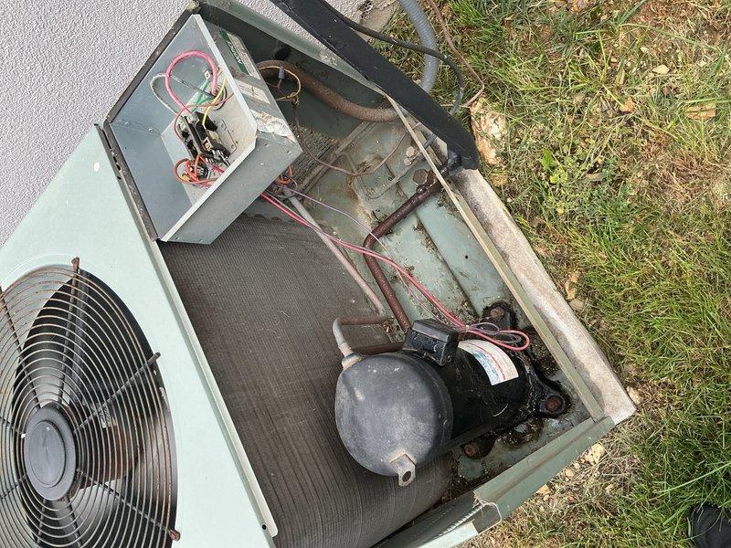 Completed preventive maintenance tune-up on existing Rheem air conditioning system. Inspected blower assembly and noted dirt accumulation on blower wheel fins requiring cleaning, examined outdoor condensing unit revealing age-related weathering with rust formation on cabinet panels, verified electrical connections and refrigerant lines, and documented equipment condition with photography for maintenance records.