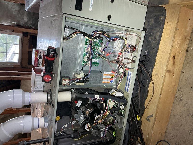 Responded to no-cooling call at bar/restaurant facility where HVAC system had ceased operation that morning. Upon inspection, accessed air handler unit mounted in utility space and performed diagnostic evaluation of electrical and mechanical components. Inspected internal wiring connections, circuit boards, capacitor, blower motor assembly, and associated control systems. Verified proper electrical connections at terminal blocks, checked capacitor specifications, and examined condensate drainage system including PVC piping and pump assembly. System was restored to operational status and tested for proper cooling function before departure.