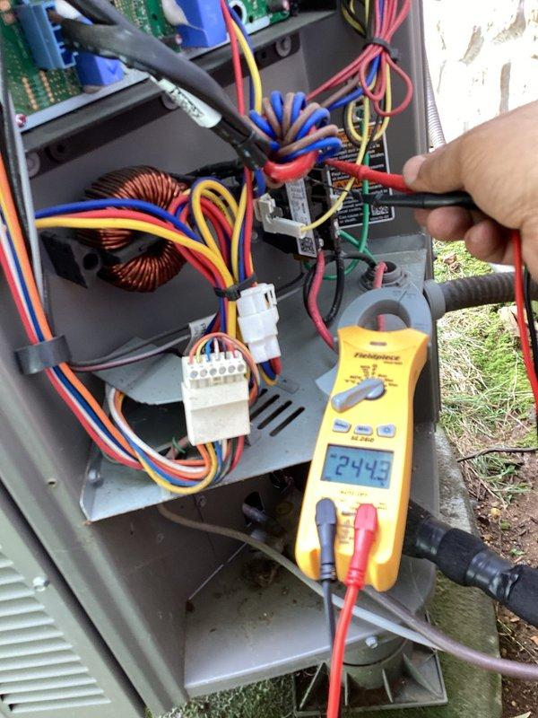 Performed air conditioning system check and provided thermostat operation education for new homeowner. Conducted electrical diagnostics on HVAC control panel, verified 24-volt control circuit operation reading 24.45 volts, and inspected all wire connections and terminal blocks for proper function. System found operating within normal parameters.