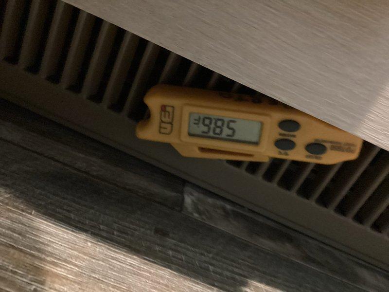 Installed and wired NEST thermostat in new residential construction to establish proper communication with air conditioning system. Verified system operation with airflow measurements at supply register reading 2985 CFM and confirmed proper temperature control functionality at air handler unit.