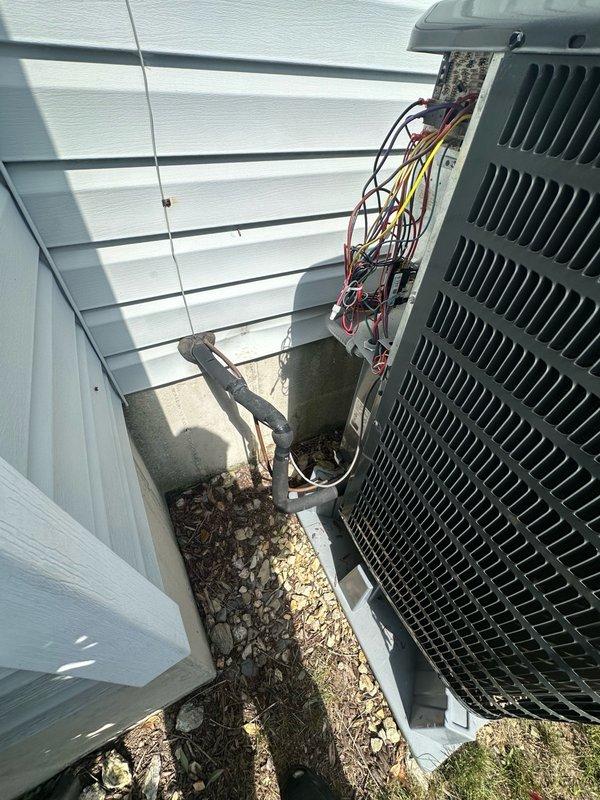 Responded to customer complaint of loud noise from outdoor condensing unit. Upon arrival, inspected exterior AC condenser and electrical components including disconnect box and wiring connections. Unit was operating and producing cold air as reported, though customer noted occasional overcooling issues. Performed visual assessment of condenser unit, electrical disconnect panel, and associated conduit. Documented equipment condition and installation setup with photographs for service records.