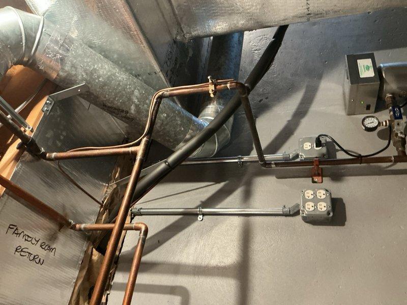 Responded to no cooling call on 25+ year old residential air conditioning system. Found indoor unit fan operating but delivering warm air with outdoor condensing unit completely non-operational. Diagnosed failed run capacitor preventing compressor and outdoor fan motor from starting. Removed defective capacitor and installed replacement unit with proper microfarad rating and voltage specifications. Verified outdoor unit startup, confirmed compressor operation, and tested system performance. Unit cooling properly upon departure.