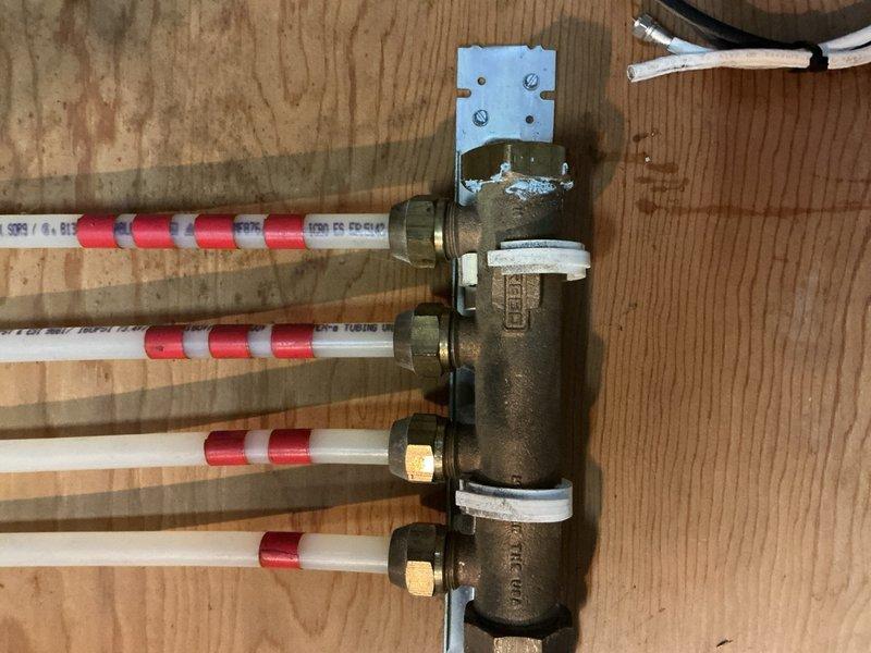 Responded to after hours emergency call for hydronic heating system issue. Upon arrival, inspected the manifold distribution system and associated copper supply piping in the mechanical space. Found pressure irregularities at the main distribution manifold serving multiple heating zones. Verified all PEX circuit connections at the manifold assembly and checked pressure gauge readings. Adjusted zone valves and bled air from the system to restore proper circulation. Confirmed all four heating circuits were functioning correctly and maintaining appropriate pressure levels before departing the premises.