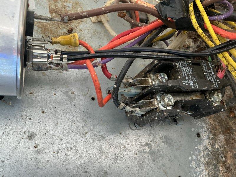 Completed preventive maintenance inspection on Rheem air conditioning system installed December 2016. Inspected electrical connections, contactors, and control wiring at outdoor unit, verifying all components operating within normal parameters. Documented existing surface corrosion on mounting panel and checked thermostat control board connections inside air handler, confirming proper wire terminations and system functionality throughout inspection process.