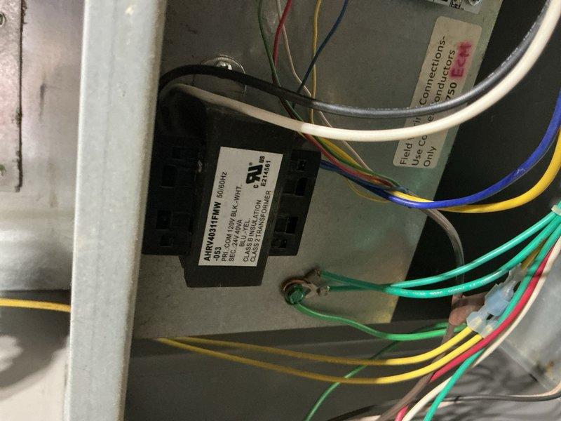 Completed preventive maintenance inspection on Rheem air conditioning system installed December 2016. Inspected electrical connections, contactors, and control wiring at outdoor unit, verifying all components operating within normal parameters. Documented existing surface corrosion on mounting panel and checked thermostat control board connections inside air handler, confirming proper wire terminations and system functionality throughout inspection process.