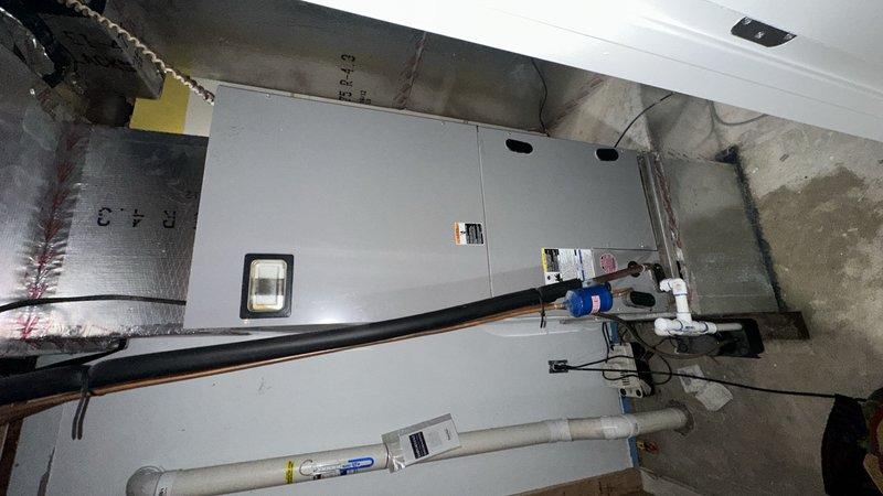 Responded to service call for central air conditioning unit leaking water in basement mechanical room. Upon inspection, identified condensate drain line issue causing water accumulation. Cleared blockage from condensate drain system, verified proper drainage flow, and tested unit operation to ensure leak was resolved and system was functioning correctly.