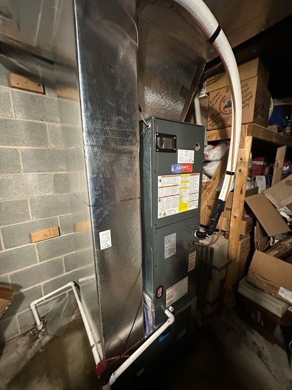 Completed full system change-out, removing existing York heat pump and installing new Moyer Comfort Series heat pump with air handler in basement mechanical room. Installation included proper refrigerant line connections, ductwork integration with existing metallic supply plenum, condensate drain piping with PVC routing, and electrical connections per manufacturer specifications.