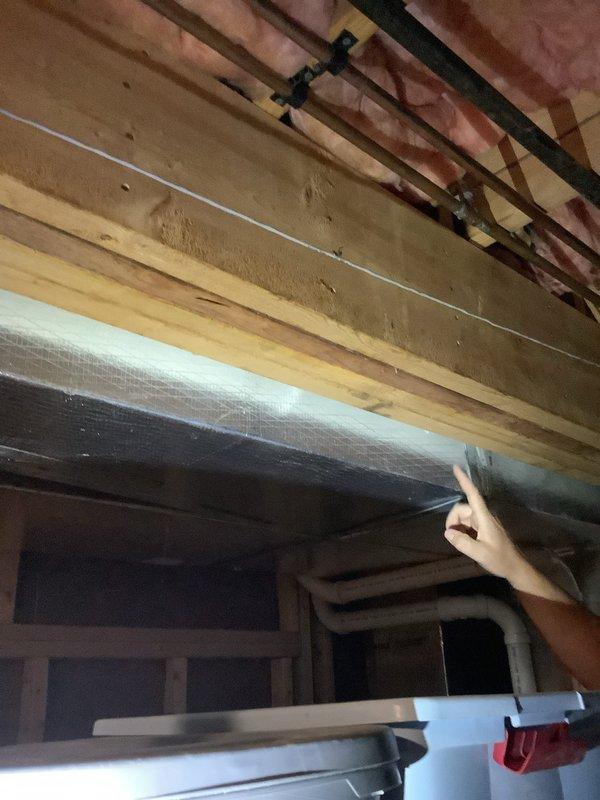 Responded to water leak in basement originating from ceiling area. Located source of leak in copper supply piping running above ductwork in unfinished section of basement, with water traveling along piping into finished area. Opened section of ceiling to access and confirm leak location. Copper piping positioned directly above duct board ductwork, creating access challenges for repair work. Documented conditions with photos showing foil-faced insulation, copper piping, PVC drainage system, and HVAC components in mechanical space. Additionally replaced supply line to upper floor sink. Discussed future scope including potential ductwork removal for proper access to copper piping, ice maker supply line upgrade to stainless steel braided line, and heat system inspection to be scheduled separately.