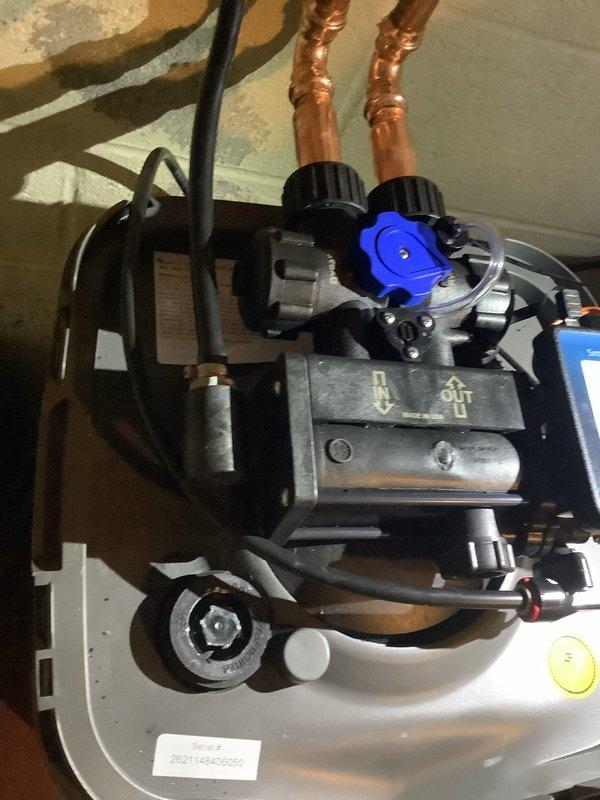 Completed water treatment system installation re-check and verified proper operation of the Smart Touch Control ST-400 unit. Performed water quality testing and documented system components including copper refrigerant lines, compressor assembly, and backwash cycle functionality to ensure installation meets specifications.