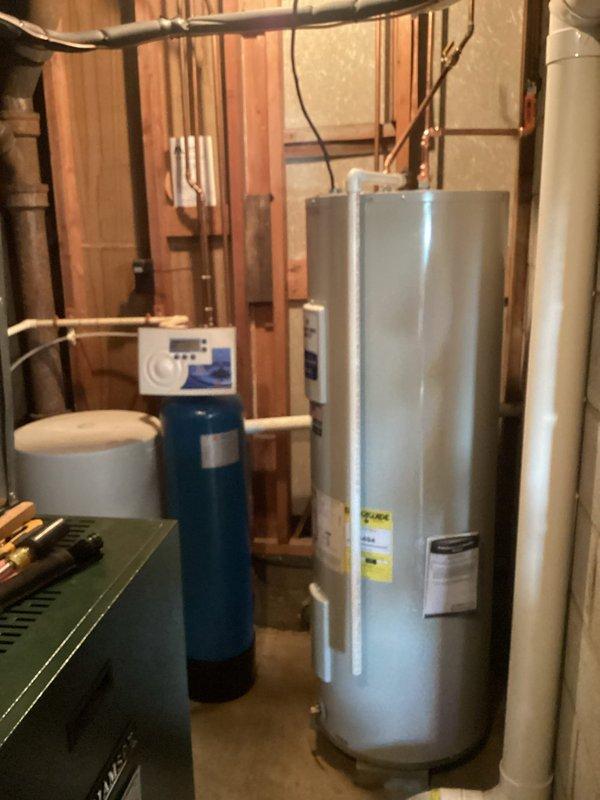 Responded to service call for leaking 50-gallon electric water heater in residential basement. Upon inspection, confirmed active leak requiring full unit replacement. Removed existing Bradford White water heater and installed new 50-gallon electric water heater with adequate clearance specifications (23" width, 58" height). Connected copper supply lines, verified proper electrical connections, and tested all plumbing connections for leaks. System commissioned successfully with no issues detected.