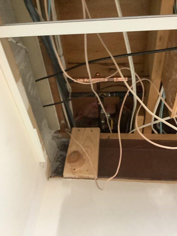 Replaced 16-year-old water treatment system that experienced significant water leakage into drain following reset button activation. Original unit had been placed in bypass mode to control leak, with display screen and keypad buttons deteriorated and difficult to read due to age. Evaluated leaking copper fitting in basement and inspected existing 16-year-old Bradford White water heater during service visit. Completed full system replacement installation with new water treatment equipment, ensuring proper connections to existing plumbing infrastructure and verifying all components functioning correctly without leaks.