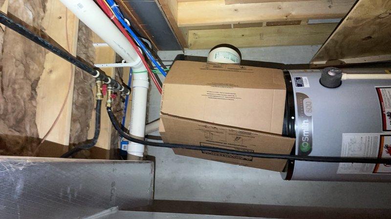 Responded to gas leak on newly installed direct vent gas water heater. Upon arrival, confirmed gas supply was shut off for safety. Inspected installation and identified improper blue plastic tubing used on gas supply line from street connection. Explained to homeowner that plastic tubing is not code-compliant for natural gas applications and poses serious safety hazard. Documented unsafe installation with photos showing the flexible plastic line connected to water heater and surrounding mechanical components. Recommended immediate replacement of plastic gas line with approved black iron pipe or corrugated stainless steel tubing (CSST) by licensed professional to meet code requirements and ensure safe operation.
