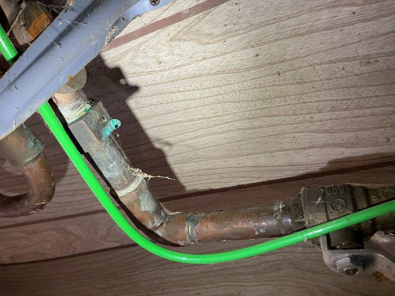 Responded to emergency plumbing call for pinhole leak on copper water main supply line entering residence. Upon arrival, found active leak with temporary container in place for water collection. Performed repair on compromised copper piping section in crawl space area. Conducted water quality testing to assess pH levels and documented findings with photographs per protocol. Based on water test results, provided quote for recommended water treatment system to address corrosive water conditions contributing to copper pipe degradation. Confirmed appointment time prior to arrival and completed all work as scheduled.