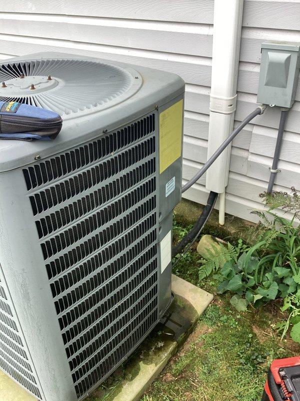 Performed preventive maintenance tune-up on Goodman heat pump system located in attic, including thorough blower wheel cleaning which had accumulated significant debris from extended service without maintenance. Conducted complete system diagnostics with electrical testing at service panel, verifying proper amperage draw and circuit operation. Inspected outdoor condenser unit, evaluated thermostat operation for reported intermittent issues, and confirmed system is functioning properly with all components operating within manufacturer specifications.