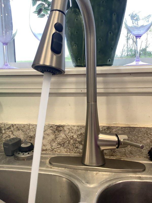 Responded to kitchen sink leak caused by failing couplings beneath the sink. Replaced defective coupling connections on water supply lines to eliminate active leak. Subsequently installed customer-supplied kitchen faucet with pull-down spray head, mounting unit on existing countertop opening and connecting to supply lines. Tested all connections for proper water flow and verified no leaks present at completion.