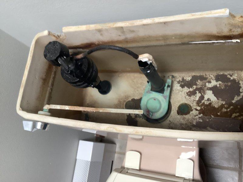Replaced two toilets in main warehouse facility. Previous units exhibited whistling noise at idle that ceased when flushed, indicating faulty fill valve operation. Old toilet tanks showed significant deterioration with extensive mineral deposits, brown staining, and corroded interior surfaces from hard water exposure. Removed existing toilets and installed new standard white porcelain units with updated fill valve and flush valve assemblies. Tested installations for proper operation and verified absence of previous noise issues.