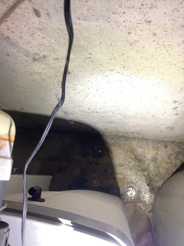 Responded to water treatment system leak originating from the rear of the acid neutralizer. Upon arrival, found leak at bypass valve assembly and successfully placed system in bypass mode to control water loss. Performed comprehensive inspection of entire water treatment system including acid neutralizer and associated components. Evaluated system for potential re-bed requirements and salt levels, noting last re-bed was completed with neutralizing solution mix in April 2024. Documented current system condition with photographs showing bypass valve configuration, piping connections, and treatment tank assembly for service records.