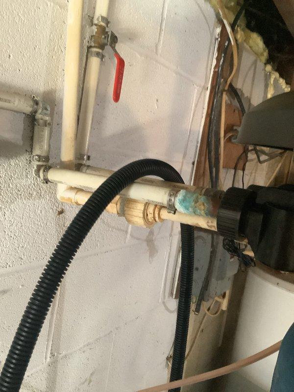 Performed maintenance service on MixMaster water softener/neutralizer system that had not been serviced in 3-4 years. Inspected regeneration cycle operation, verified system settings, and reset controls as needed for single-occupant household usage. Documented existing plumbing configuration including copper piping with visible corrosion at connection points and PVC supply lines with ball valve controls.