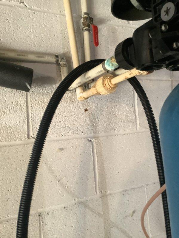 Performed maintenance service on MixMaster water softener/neutralizer system that had not been serviced in 3-4 years. Inspected regeneration cycle operation, verified system settings, and reset controls as needed for single-occupant household usage. Documented existing plumbing configuration including copper piping with visible corrosion at connection points and PVC supply lines with ball valve controls.