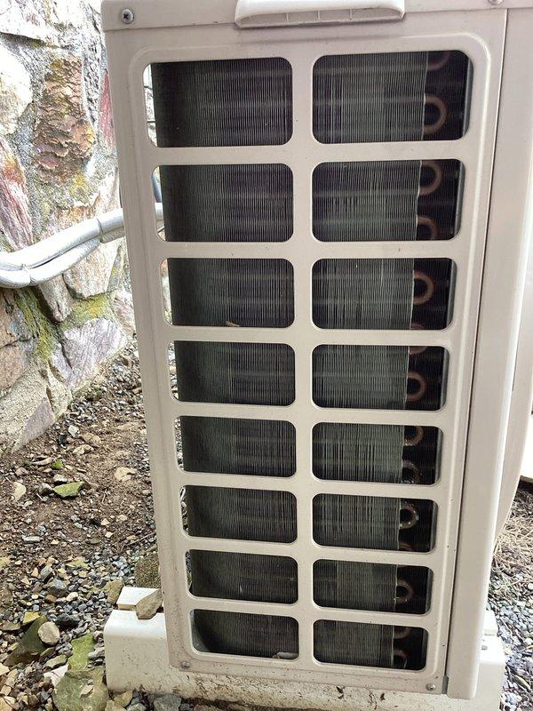 Completed CPM oil heating inspection at property with no existing oil equipment found on file. Documented HVAC equipment with photographs showing Samsung heat pump system installed in August 2021, positioned on exterior concrete pad with refrigerant lines running along foundation wall. Heat pump evaluation scheduled as separate service to verify system operation and performance.