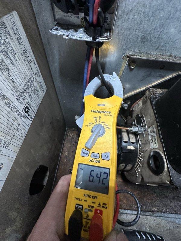 Completed comprehensive cleaning and servicing of 1999 Armstrong oil heating system. During inspection, identified elevated flue temperatures indicating potential soot buildup or oversized nozzle requiring monitoring and possible downsizing. Documented system performance with electrical readings showing 642mA and photographed ductwork connections; recommended fall follow-up to assess combustion efficiency and determine if nozzle adjustment is necessary.