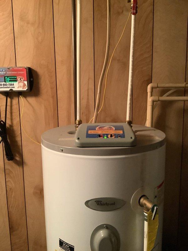 Replaced 15-year-old electric Whirlpool water heater that was leaking at the base. Removed and disposed of failed unit, installed new Whirlpool electric water heater with proper connections and controls. Additionally removed old water treatment system that had been previously discussed and was no longer in use. Verified all electrical connections, tested unit operation, and confirmed proper functionality of new installation.