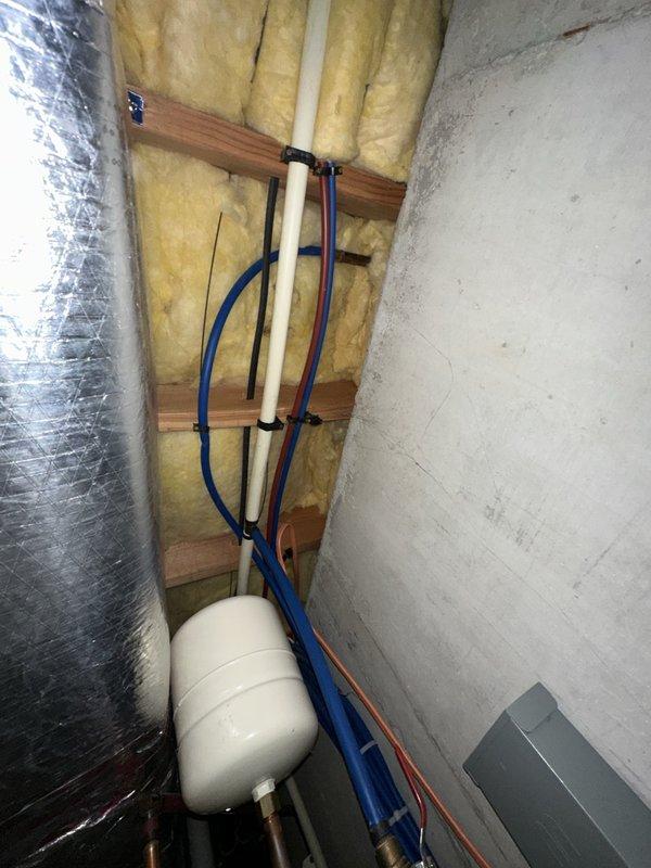 Repaired two leaking outdoor hose bibs: serviced the rear exterior hose bib that was leaking behind the siding, and rebuilt the leaking garage hose bib using the customer-supplied rebuild kit. Inspected the supply lines and expansion tank in the mechanical space, and no additional leaks, rust, or cracking were observed.