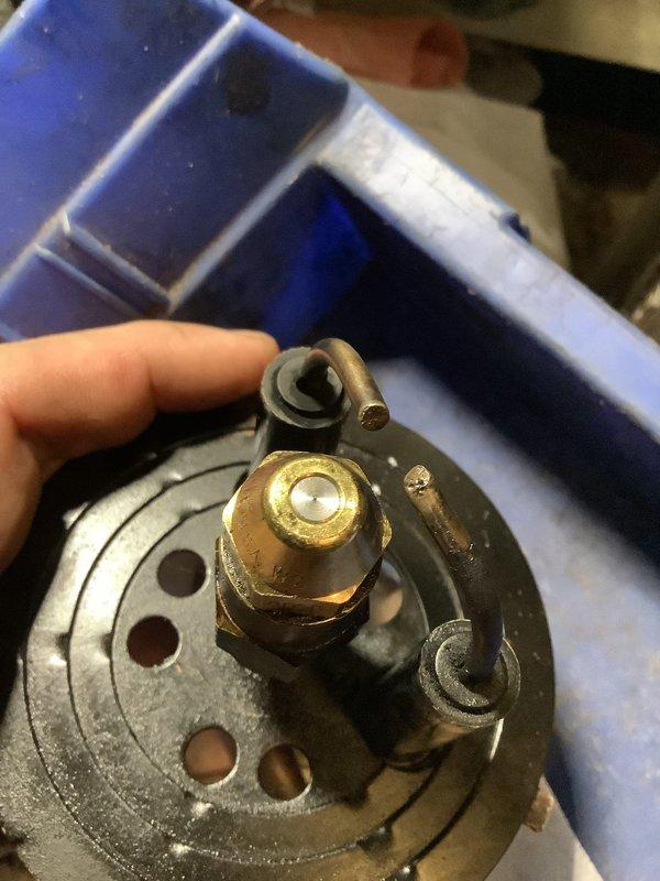 Performed annual cleaning and service on a 45-year-old Miller oil-fired furnace, including removal and cleaning of the burner assembly and replacement of the nozzle with a .60 x 80B. Inspected the blower compartment and squirrel cage wheel, noting dust accumulation on the blades and surface rust on the cabinet mounting bracket.
