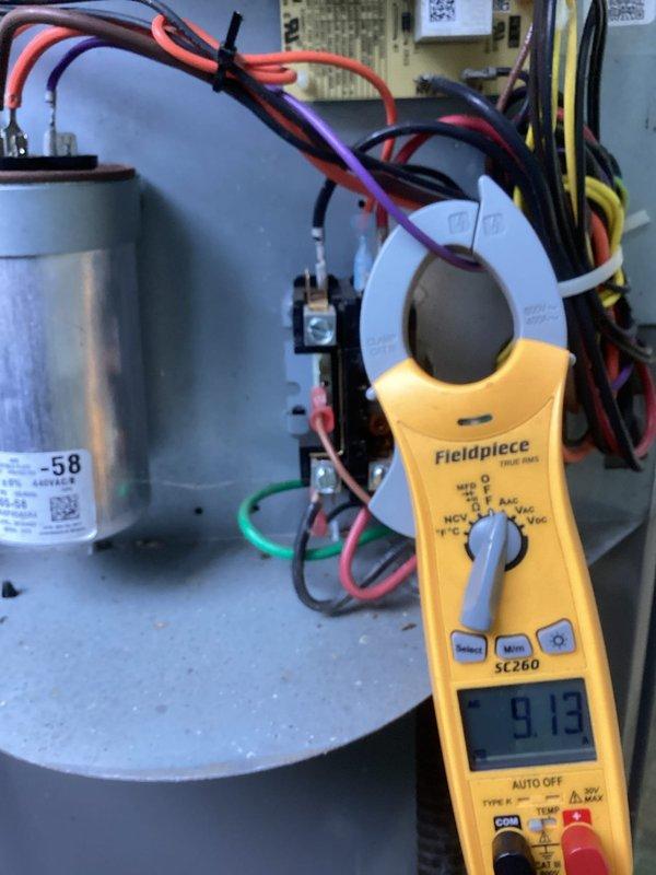 Responded to a callback for a boiler leak and loss of hot water. Performed electrical diagnostics, measuring condenser compressor circuit amperage (9.13 A) at the contactor and capacitor section, and verifying control voltage (approx. 24 V) at the air handler transformer and circuit breakers to confirm proper electrical operation.