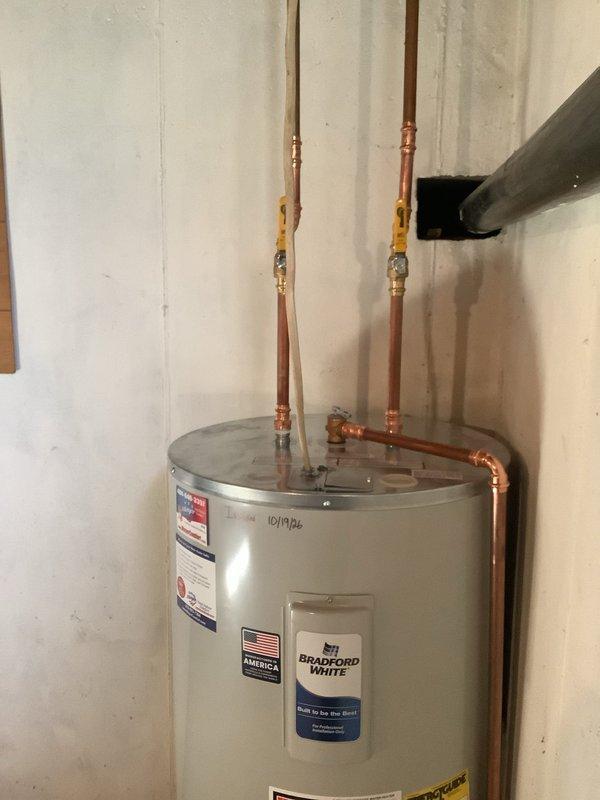Replaced the existing water heater with a new Bradford White unit, reconnecting the hot and cold supply lines with copper piping and ball isolation valves, and routing the flue and discharge piping to code. Also replaced the basement shutoff valve serving the exterior hose spigot to restore proper isolation and operation.