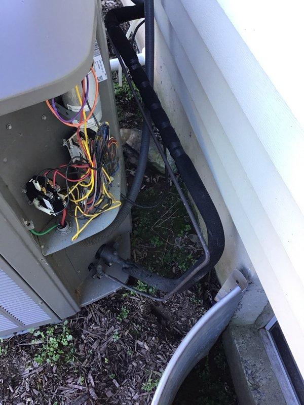 Performed a heat pump tune-up on a Lennox system installed in 2018, inspecting the indoor air handler and outdoor condenser including the electrical compartment, contactor, capacitor, and wiring. Observed heavy mold/mildew staining and buildup on the blower housing and dust accumulation on the motor and wiring, and documented blower wheel cleaning as a recommended repair for system efficiency and indoor air quality.