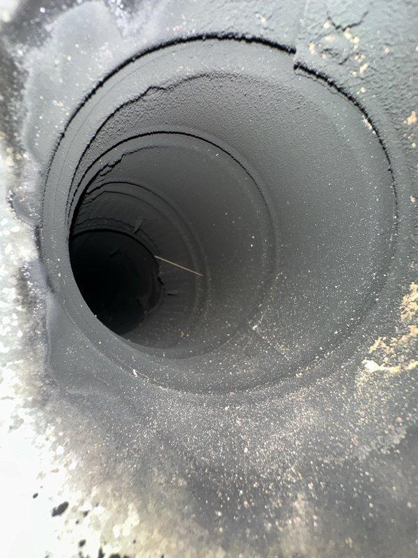 Performed a complete oil burner tune-up on the existing Kneck 2000 unit, including cleaning the heavily sooted flue pipe and burner components, replacing the nozzle with a .75 x 70B, and installing a new Beckett spin-on pressure filter element. Verified burner motor operation with an amperage reading of 0.76 A, confirming normal electrical draw.