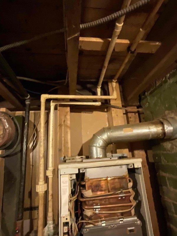 Conducted assessment for tankless water heater installation in mechanical room with existing HVAC system. Evaluated current plumbing configuration, including copper and PVC piping network running through basement ceiling joists, and noted multiple shut-off valves that would require integration with new system. Recommended appropriate tankless unit based on home's infrastructure and ventilation requirements.