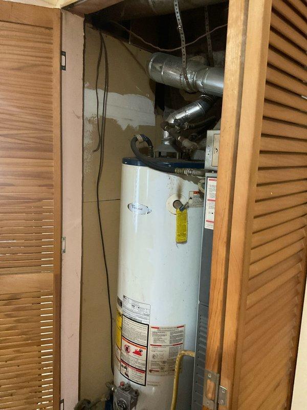 Conducted comprehensive assessment of existing HVAC system, including a Whirlpool water heater and furnace unit with associated ductwork and gas connections housed in utility closet. Evaluated potential replacement options for both heating system and water heater (including tankless alternatives), documenting current installation configuration and space constraints for proper system sizing and compatibility recommendations.