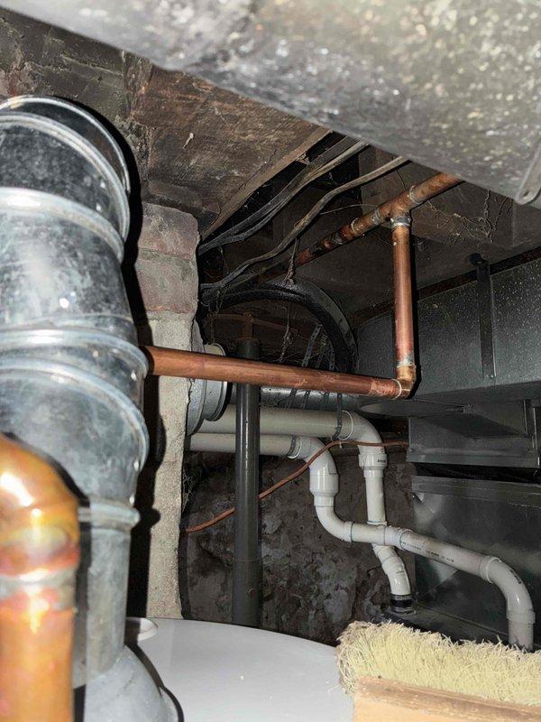 Successfully installed a new tanked water heater in the basement utility area. Completed all required copper and PVC pipe connections, including installation of a brass shut-off valve with red handle. System was tested and confirmed to be functioning properly with no leaks observed.