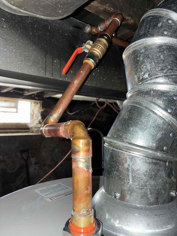 Successfully installed a new tanked water heater in the basement utility area. Completed all required copper and PVC pipe connections, including installation of a brass shut-off valve with red handle. System was tested and confirmed to be functioning properly with no leaks observed.