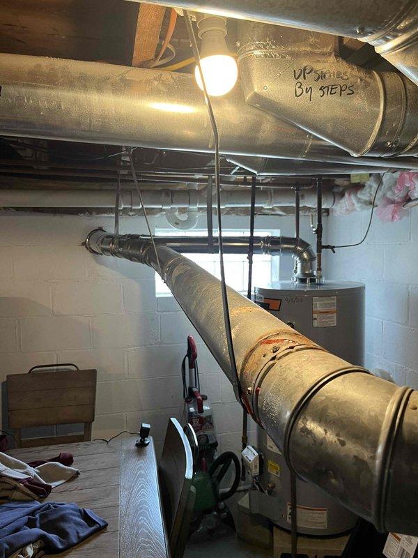 Diagnosed water heater issue reported as "WH will not stay lit" (reference #12-489). Inspected venting system and identified improper installation not meeting manufacturer specifications. Reviewed installation manual with customer, highlighting proper chimney termination requirements and carbon monoxide safety concerns. Recommended proper venting modifications to ensure safe and reliable operation.