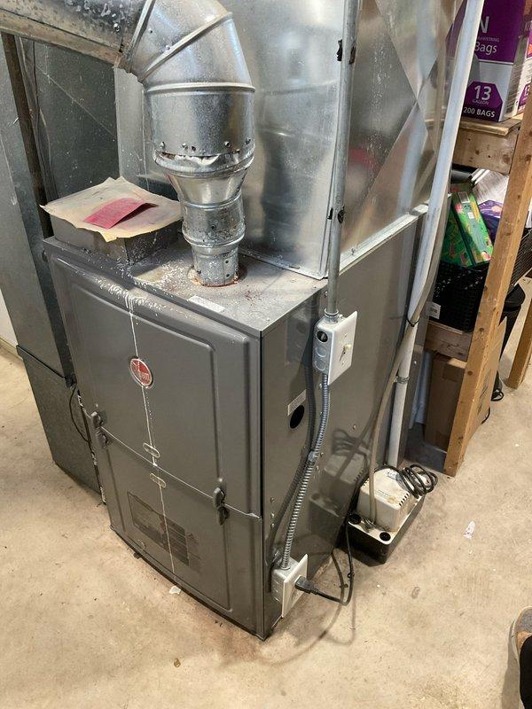 Completed estimate for replacement of aging HVAC system and water heater in residential basement. Assessment included evaluation of existing furnace with galvanized ductwork and outdated GE water heater. Photos documented current installation conditions to support replacement recommendations outlined in quotes CQ 03542-04, 03542-05, and 03542-11.