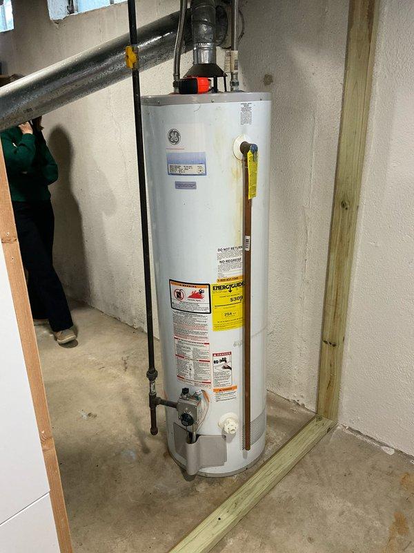 Completed estimate for replacement of aging HVAC system and water heater in residential basement. Assessment included evaluation of existing furnace with galvanized ductwork and outdated GE water heater. Photos documented current installation conditions to support replacement recommendations outlined in quotes CQ 03542-04, 03542-05, and 03542-11.