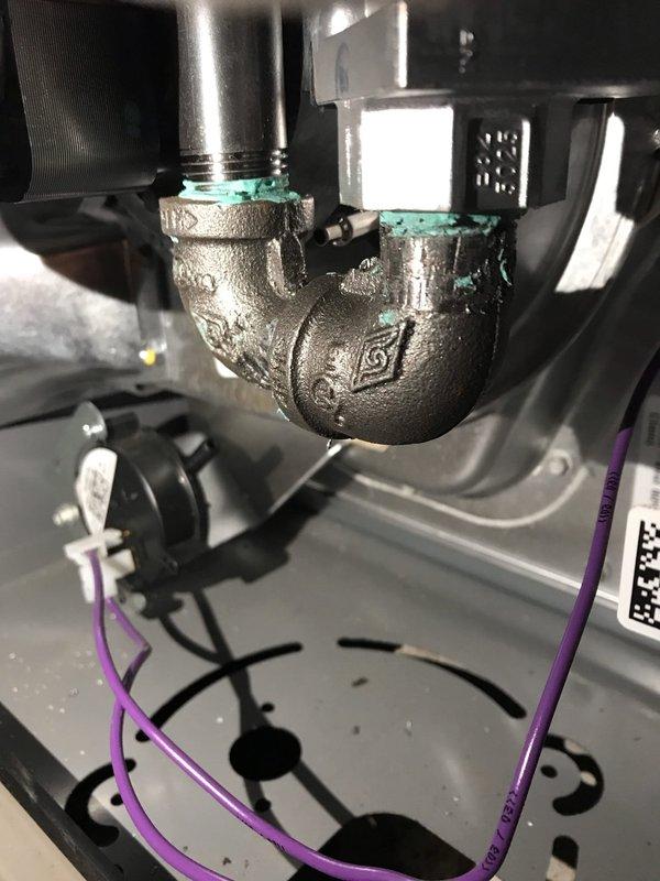 Responded to callback for furnace blowing cold air. Inspection revealed corrosion at the plumbing connection points of the heat exchanger. Replaced faulty flame sensor that was failing to properly detect flame presence, which was causing system to shut down heating cycle prematurely.