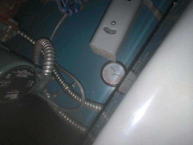 Responded to no-heat complaint for 10+ year old boiler system that was reportedly making ticking sounds while off. Inspection revealed extensive corrosion on copper pipes throughout the installation and confirmed abnormal noises emanating from the pressure regulation system. Replaced faulty pressure regulator and purged air from the system, which resolved the ticking issue and restored proper heating function.