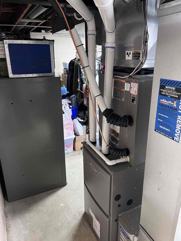 Successfully installed a complete HVAC system in the basement mechanical room, including a new furnace unit with proper PVC venting and a new air conditioning unit. The installation included connecting all required ductwork with proper insulation and elbow joints, ensuring all components were properly secured and labeled according to industry standards.