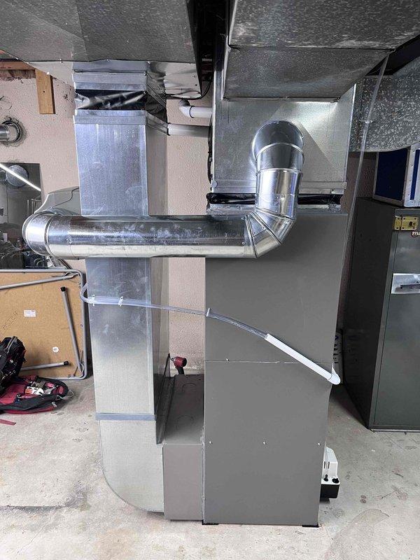 Successfully installed a complete HVAC system in the basement mechanical room, including a new furnace unit with proper PVC venting and a new air conditioning unit. The installation included connecting all required ductwork with proper insulation and elbow joints, ensuring all components were properly secured and labeled according to industry standards.