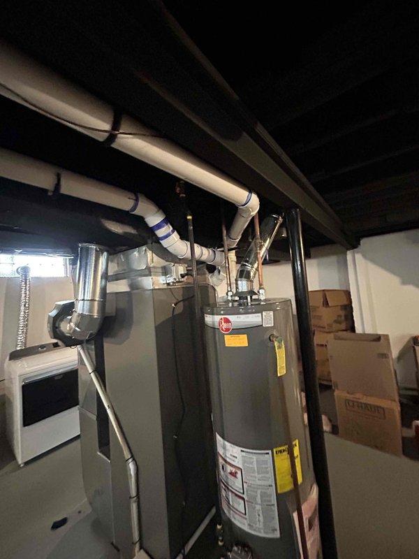 Responded to callback for possible recall issue involving cellular core PVC venting. Inspected basement HVAC system including furnace/air handler and water heater setup. Replaced non-compliant cellular core PVC venting with code-approved materials and corrected installation to satisfy permit requirements.