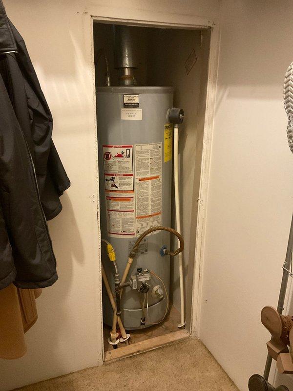 Conducted a comprehensive water heater replacement estimate for a unit installed in a recessed closet. Inspection revealed aging unit with standard connections to gas line and water pipes. Documented structural considerations including ceiling cavity access and existing insulation that would impact installation requirements. Recommended replacement with applicable discount coupon available.